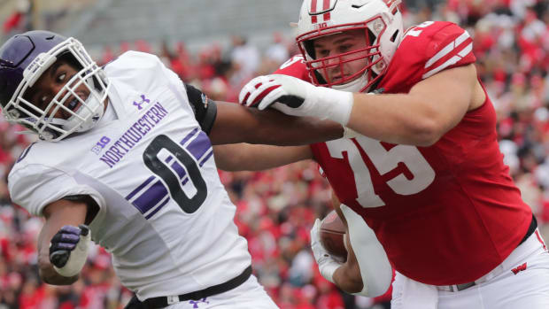 Wisconsin center Joe Tippmann pancakes a Northwestern player
